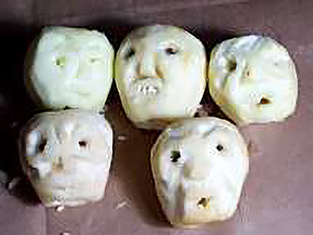 a batch of freshly carved apple zombie heads