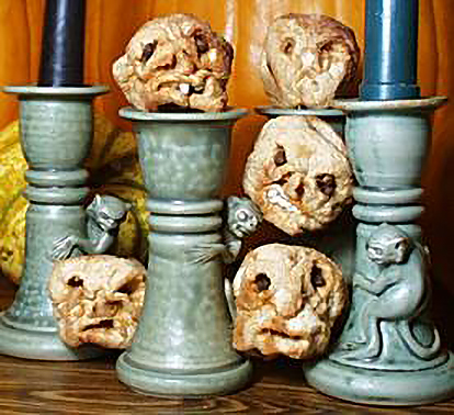 a display of multiple carved apple zombie heads