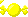a pixel art cursor that looks like a yellow piece of wrapped candy